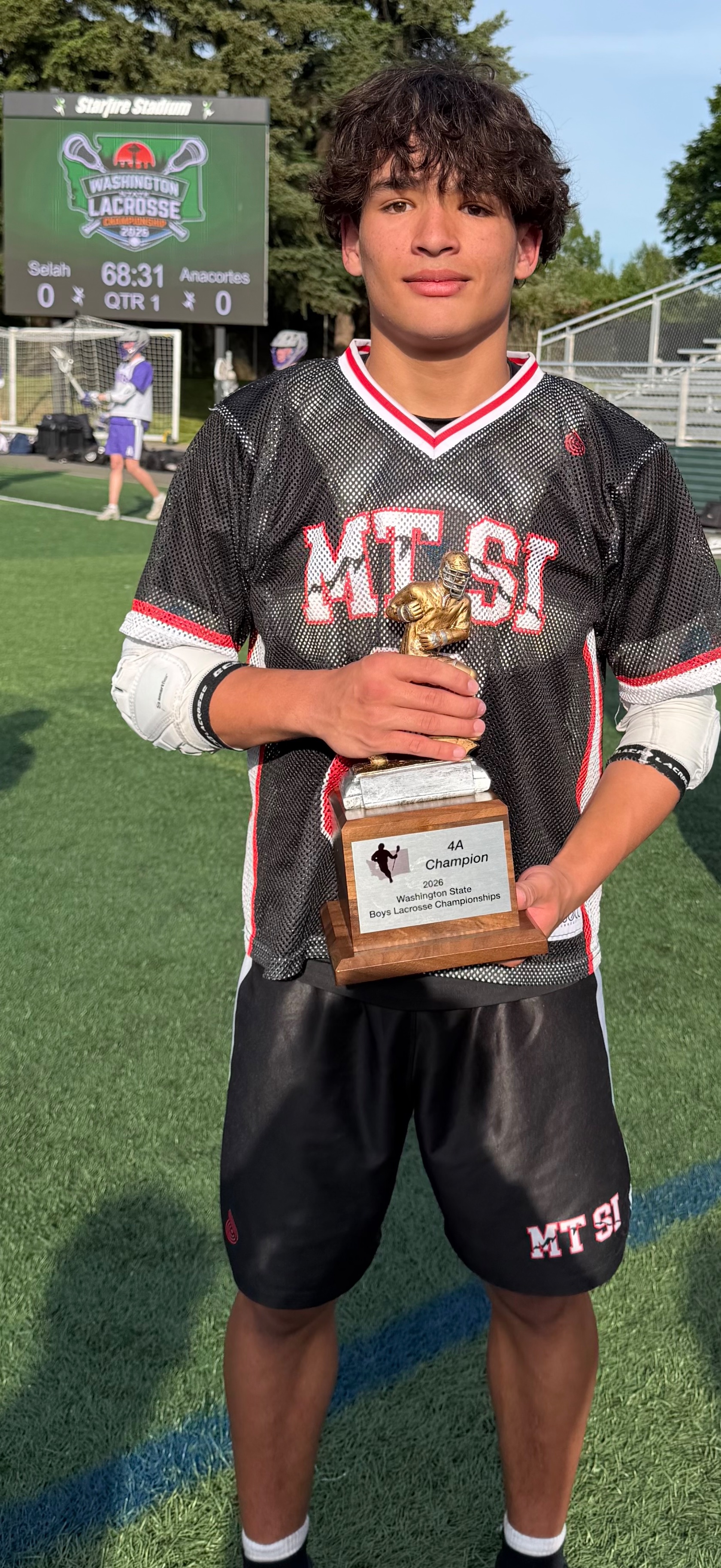 John Larson in his Mount Si jersey holding the 2026 Washington State 4A championship trophy